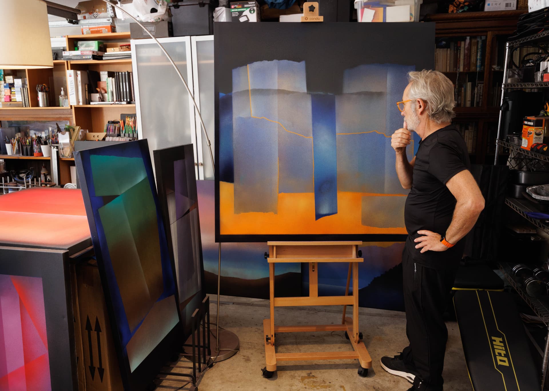Jorge Engel considering Dancing Fools on an easel in his studio